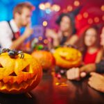 Jack O Lantern,on,bar,counter,and,friends,on,background