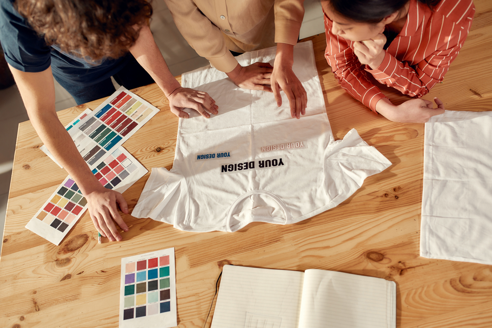 Creative,people,trying,on,stickers,with,text,,while,discussing,logo